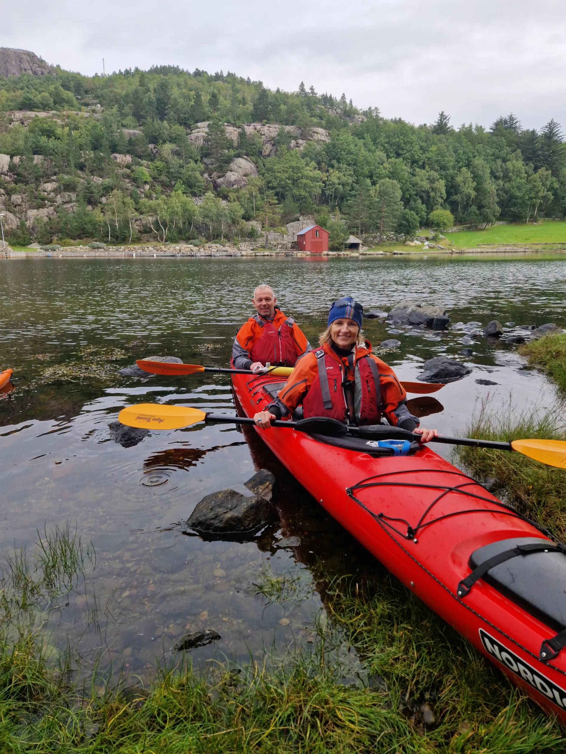 Kayaker preparing to set off on a Norwegian fjords adventure with gear for kayaking and wild camping