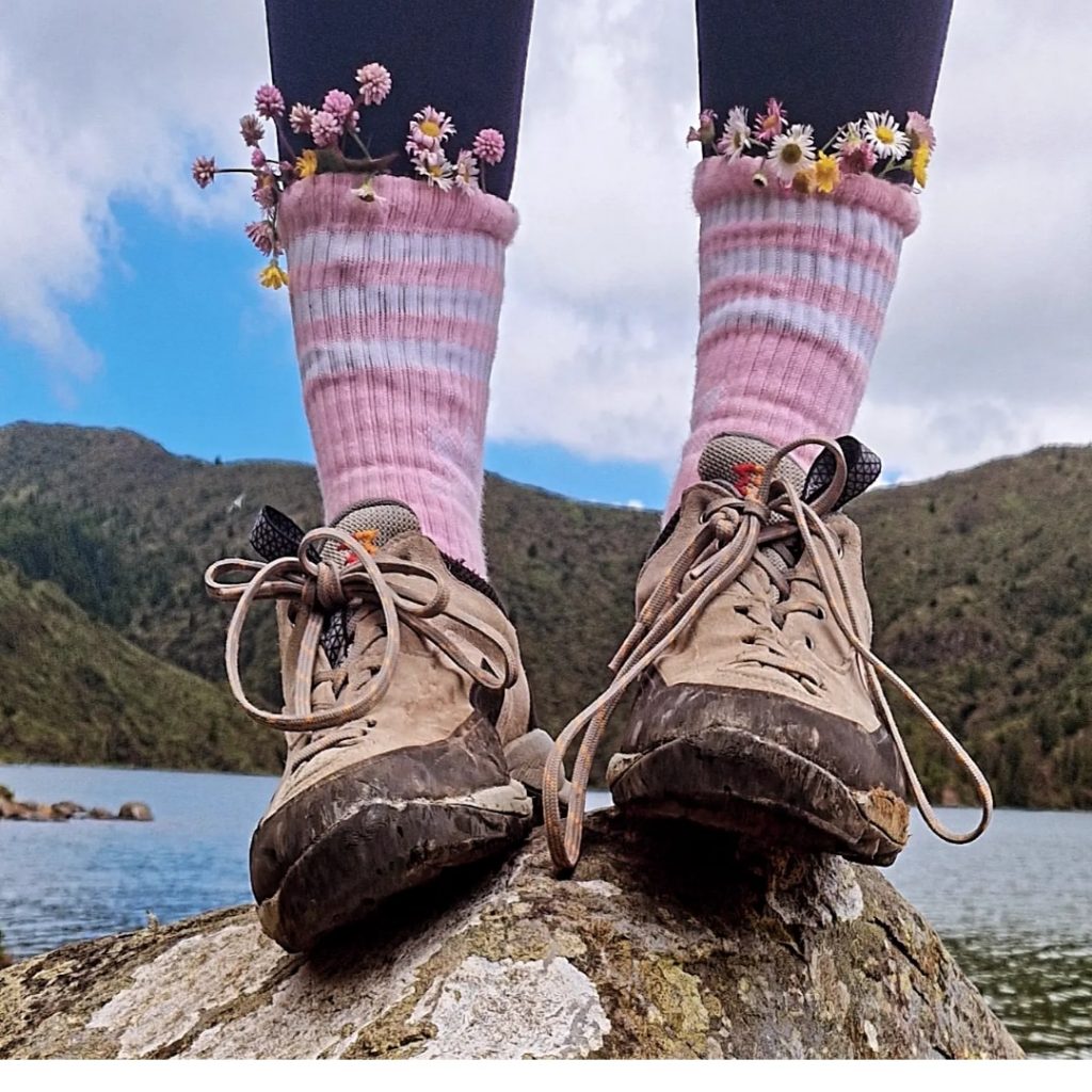 Standing on a rock in a lake in São Miguel, Azores during a hiking adventure