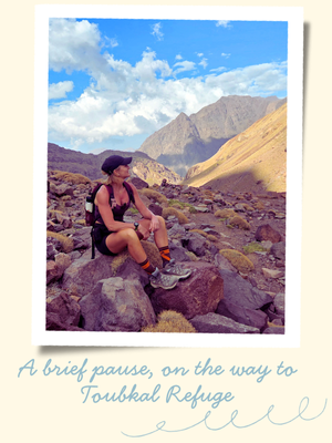 Woman taking a break on the climb from Imlil to the Toubkal refuge, the route to Morocco’s highest summit