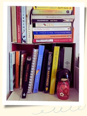 Stack of books on a decluttered shelf in a tidy apartment